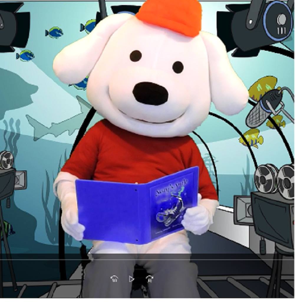 Storytime Pup reading a children's book